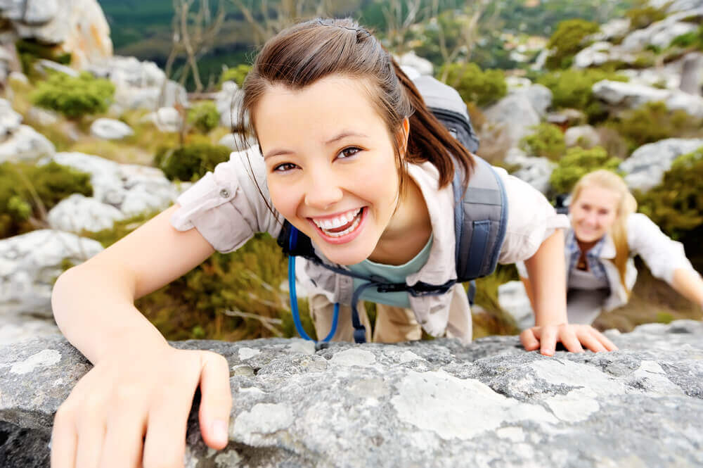 Young woman rock climbing without glasses