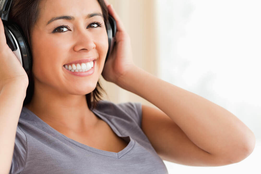 Young woman smiling wearing headphones